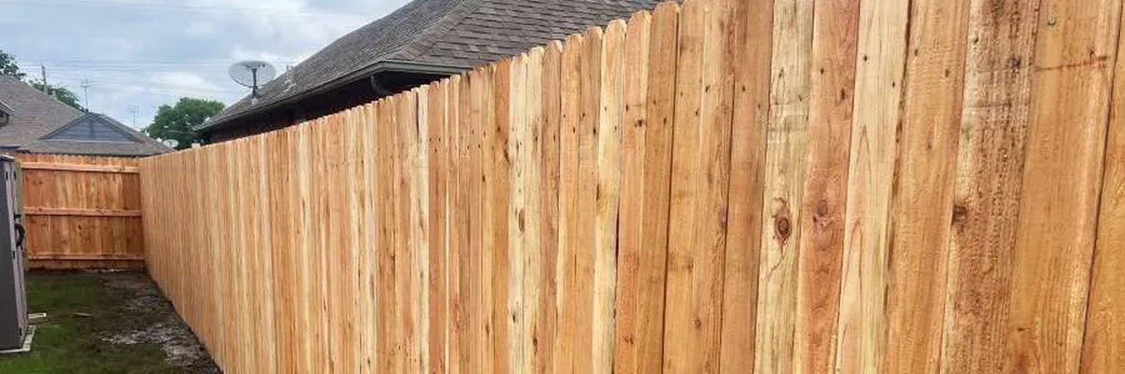 Six-foot cedar privacy fence with cap rail installed along an Edinburg back yard property line